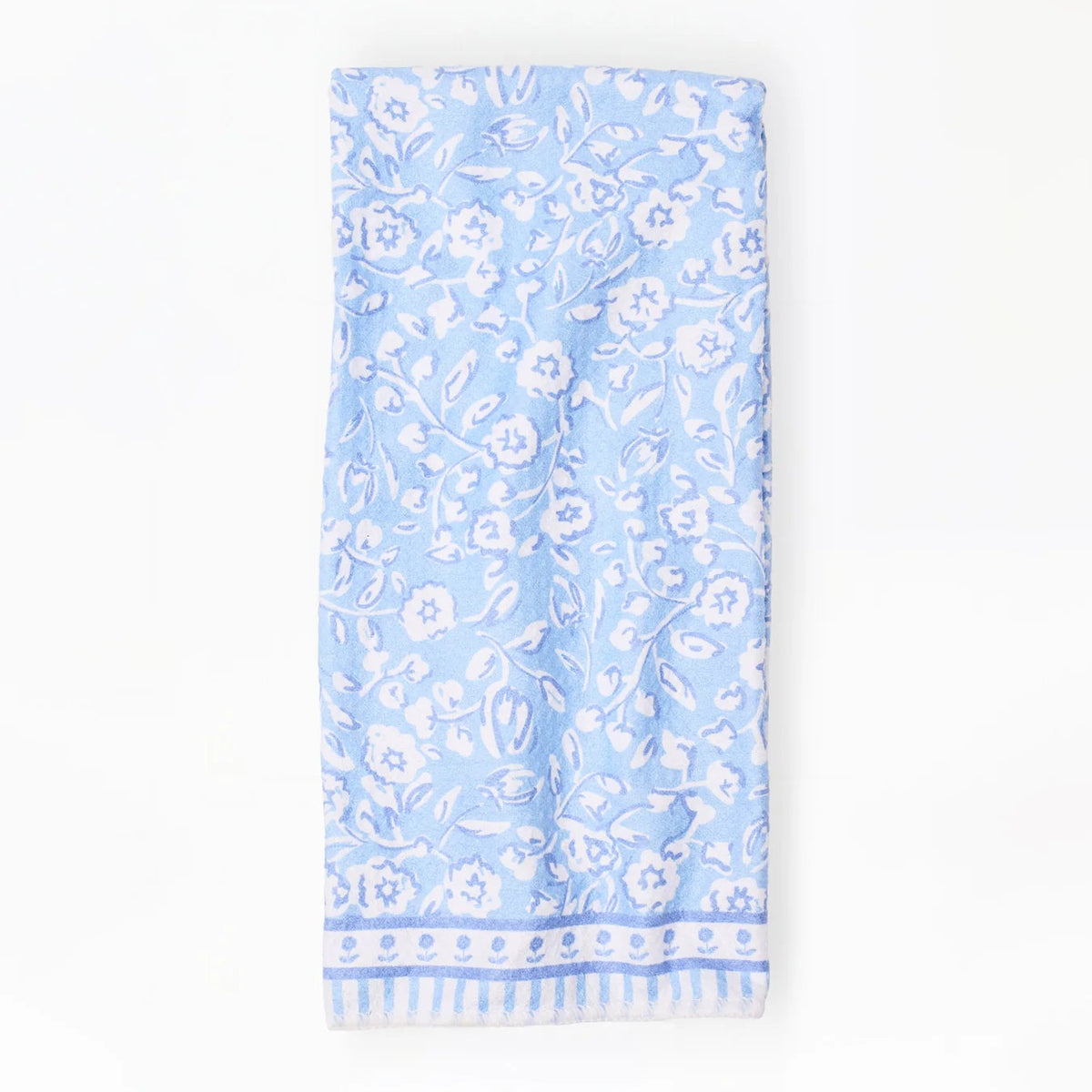 Light blue towel with white floral pattern on a white background